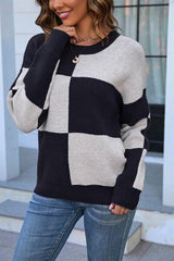 a woman wearing a black and white checkered sweater