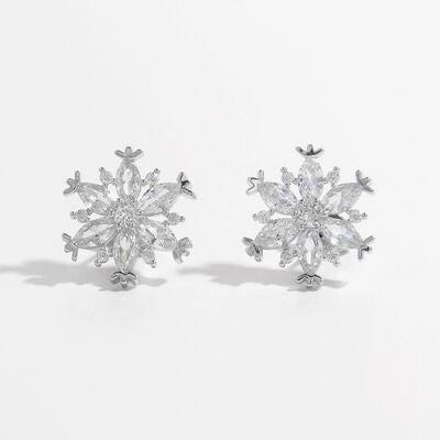 a pair of snowflake earrings on a white background