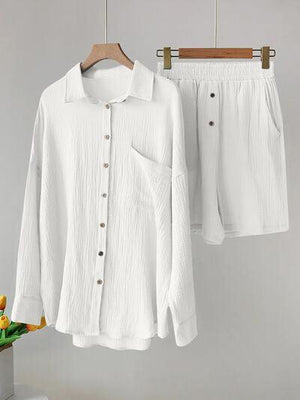 a white shirt and shorts hanging on a clothes rack