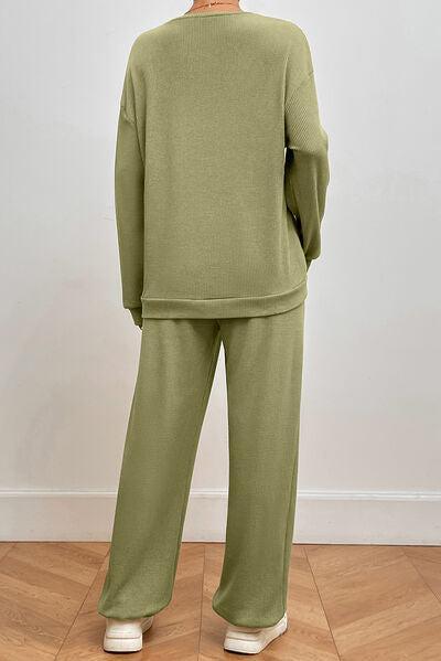 a woman wearing a green sweater and pants