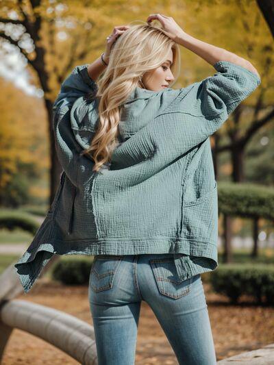 a woman standing in a park with her hands on her head