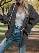 a woman posing for a picture in a park