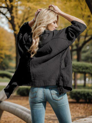 a woman in jeans and a black jacket