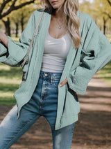 a woman posing for a picture in a park