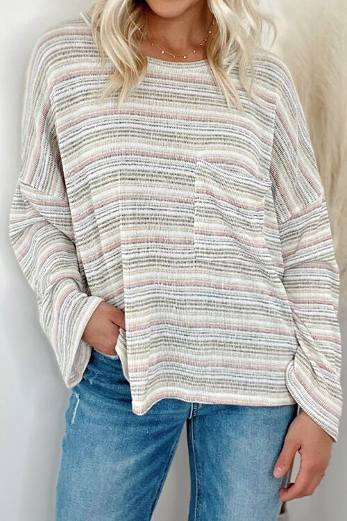 a woman wearing a striped sweater and jeans