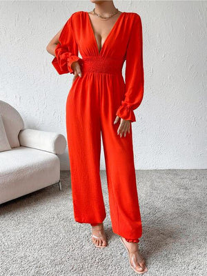 a woman in a red jumpsuit posing for a picture