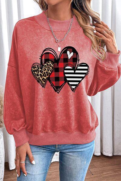 a woman wearing a red sweater with hearts on it