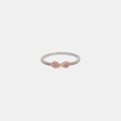 a white and pink diamond ring on a white background