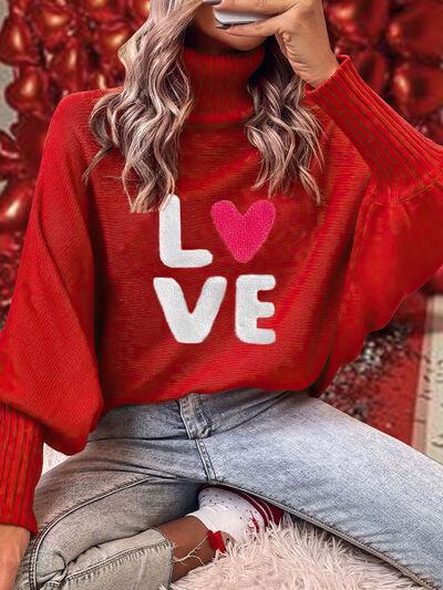 a woman wearing a red sweater with the word love on it