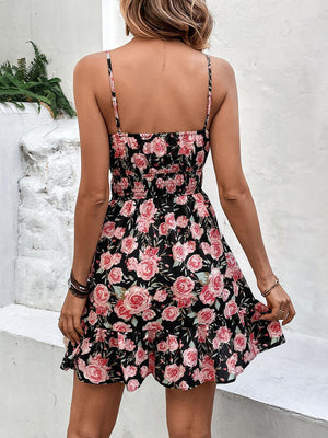 a woman in a black and pink floral dress