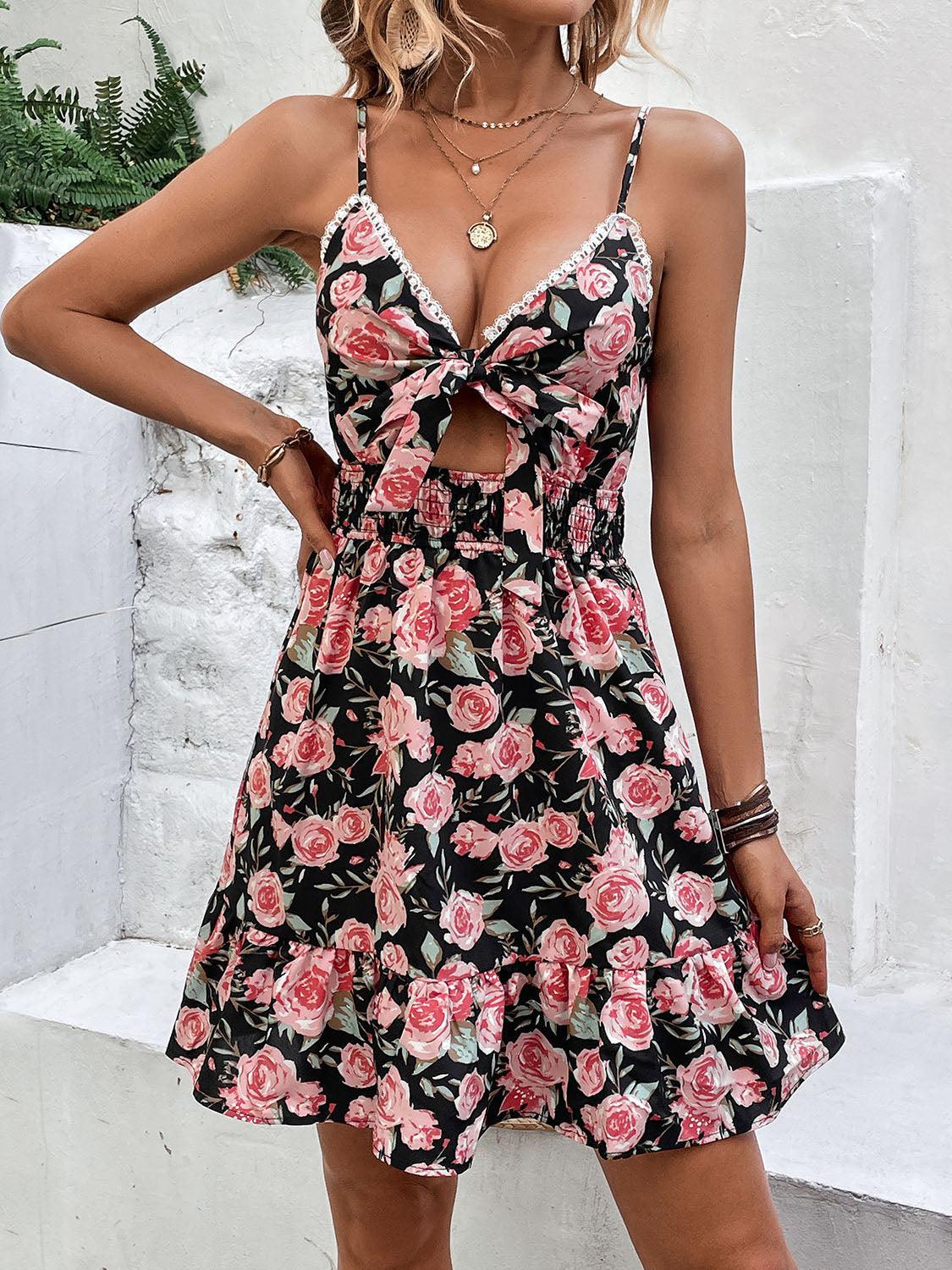 a woman in a floral dress posing for a picture