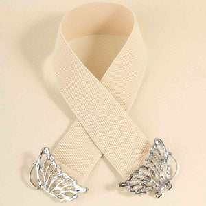 a white ribbon with a butterfly brooch on it