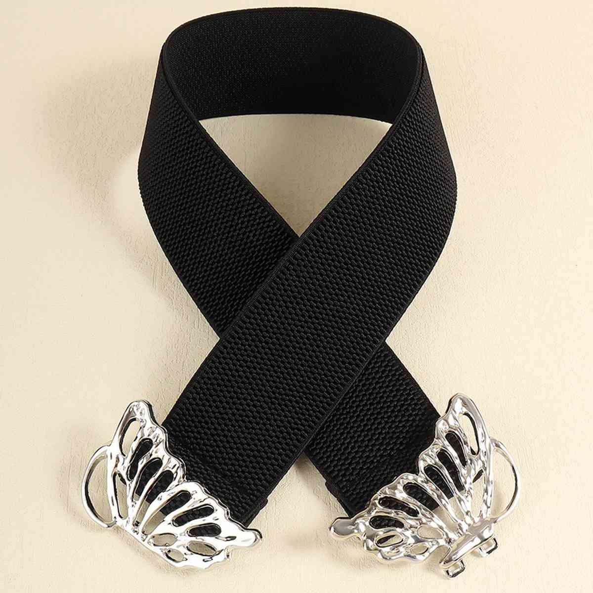 a black ribbon with silver metal wings on it