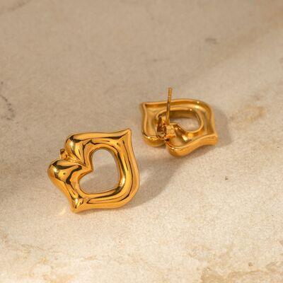 a pair of gold earrings on a marble surface