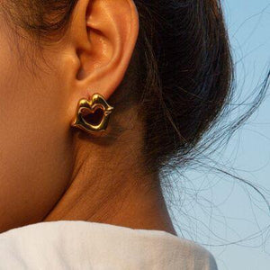 a close up of a person wearing a pair of earrings