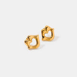 a pair of gold earrings with the letter c