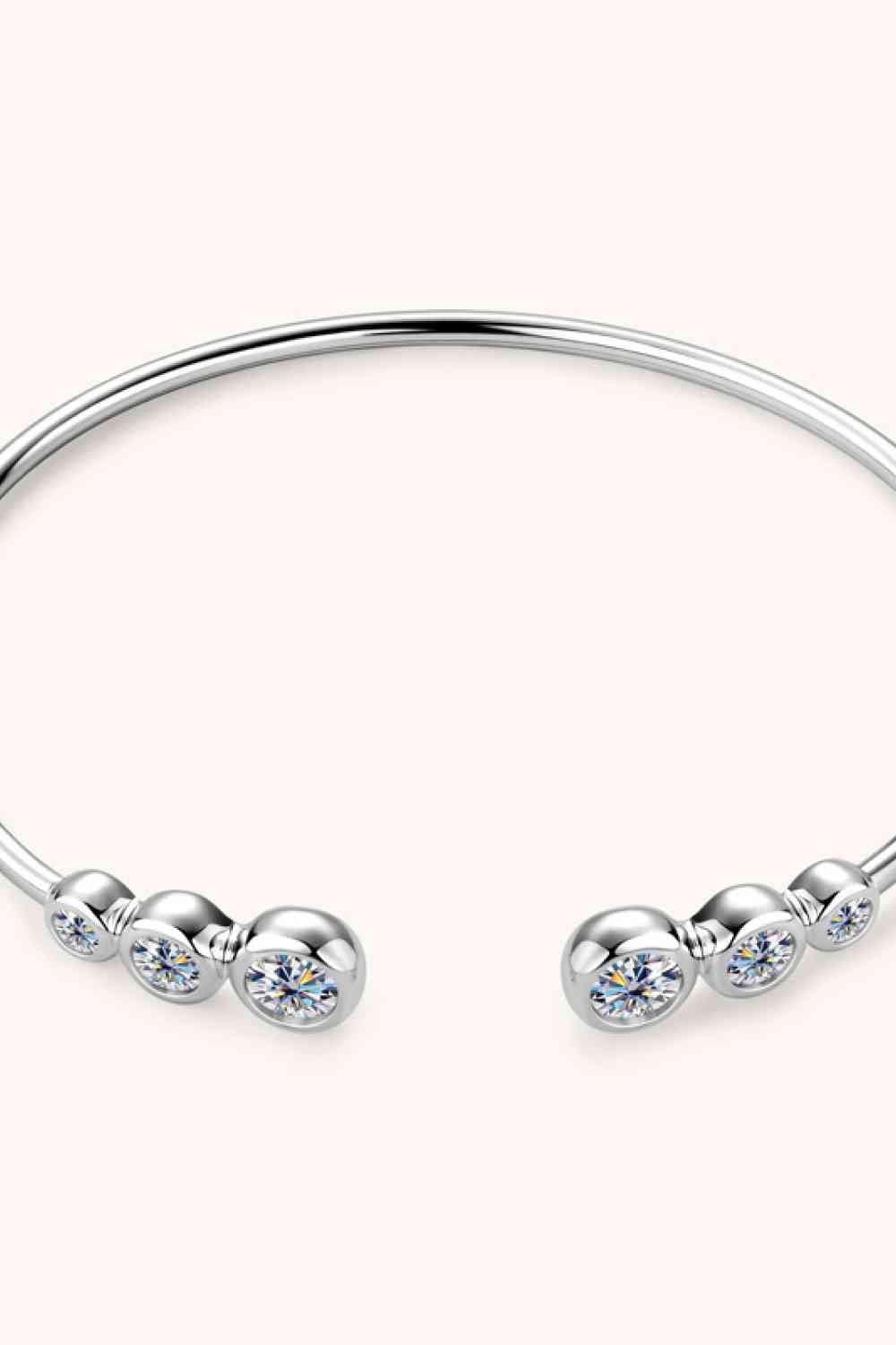 a silver bracelet with three stones on it