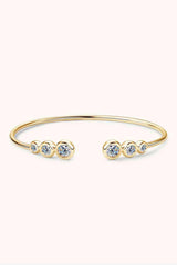 a gold bracelet with three stones on it