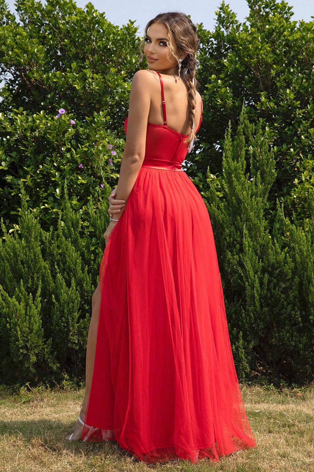 a woman in a red dress standing in a field