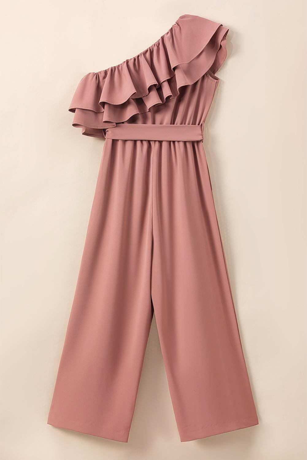 a pink jumpsuit hanging on a wall