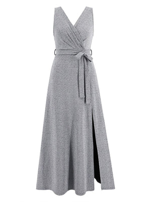 a woman wearing a gray dress with a slit