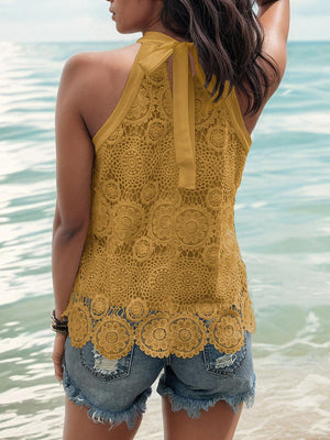 a woman standing in the water wearing a yellow top