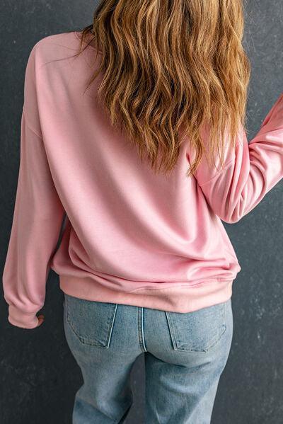 the back of a woman's head wearing a pink sweatshirt