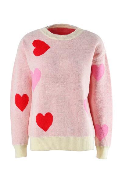 a pink sweater with hearts on it