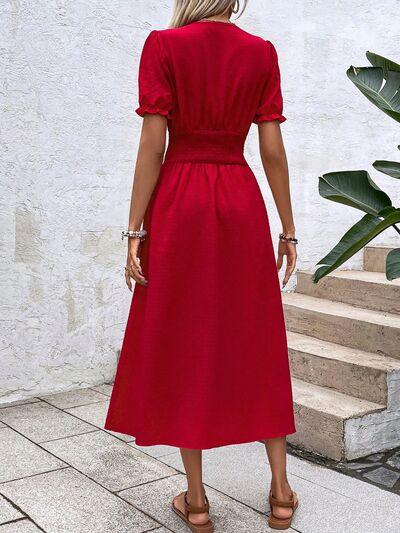 a woman wearing a red dress and sandals