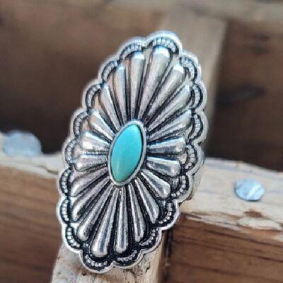 a silver ring with a turquoise stone in the center