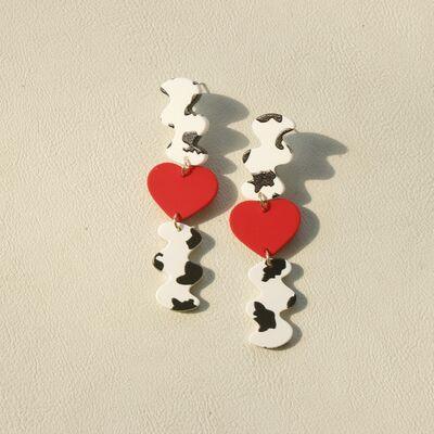 a pair of red and white heart shaped earrings