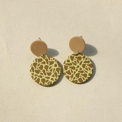 a pair of earrings with a giraffe print