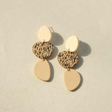 a pair of earrings on a white surface