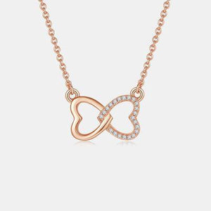 a rose gold necklace with a diamond heart