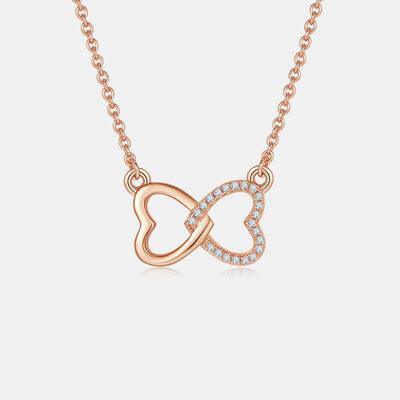 a rose gold necklace with a diamond heart