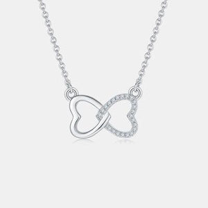 a silver necklace with a heart and a diamond