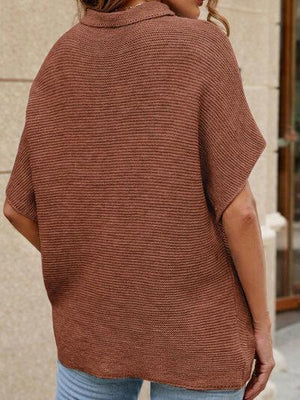 a woman wearing a brown sweater and jeans