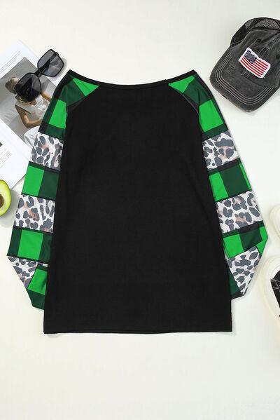 a black and green top with leopard print sleeves