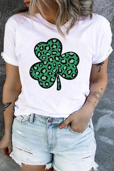 a woman wearing a white t - shirt with a green four leaf clover