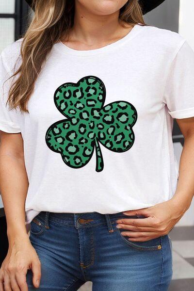 a woman wearing a white shirt with a green clover on it