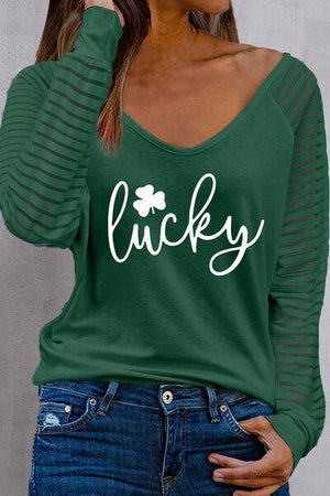 a woman wearing a green shirt that says lucky