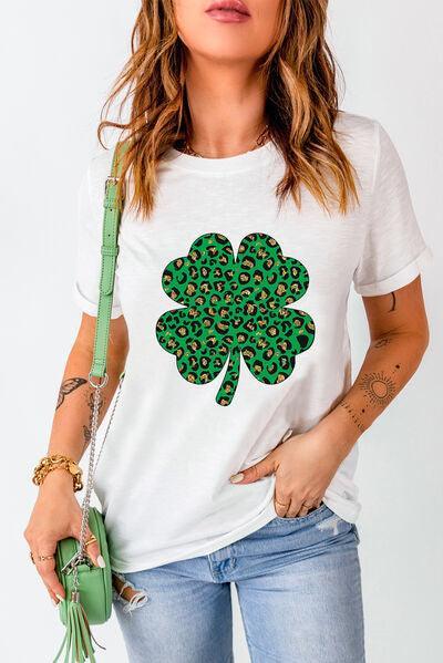 a woman wearing a white t - shirt with a shamrock on it