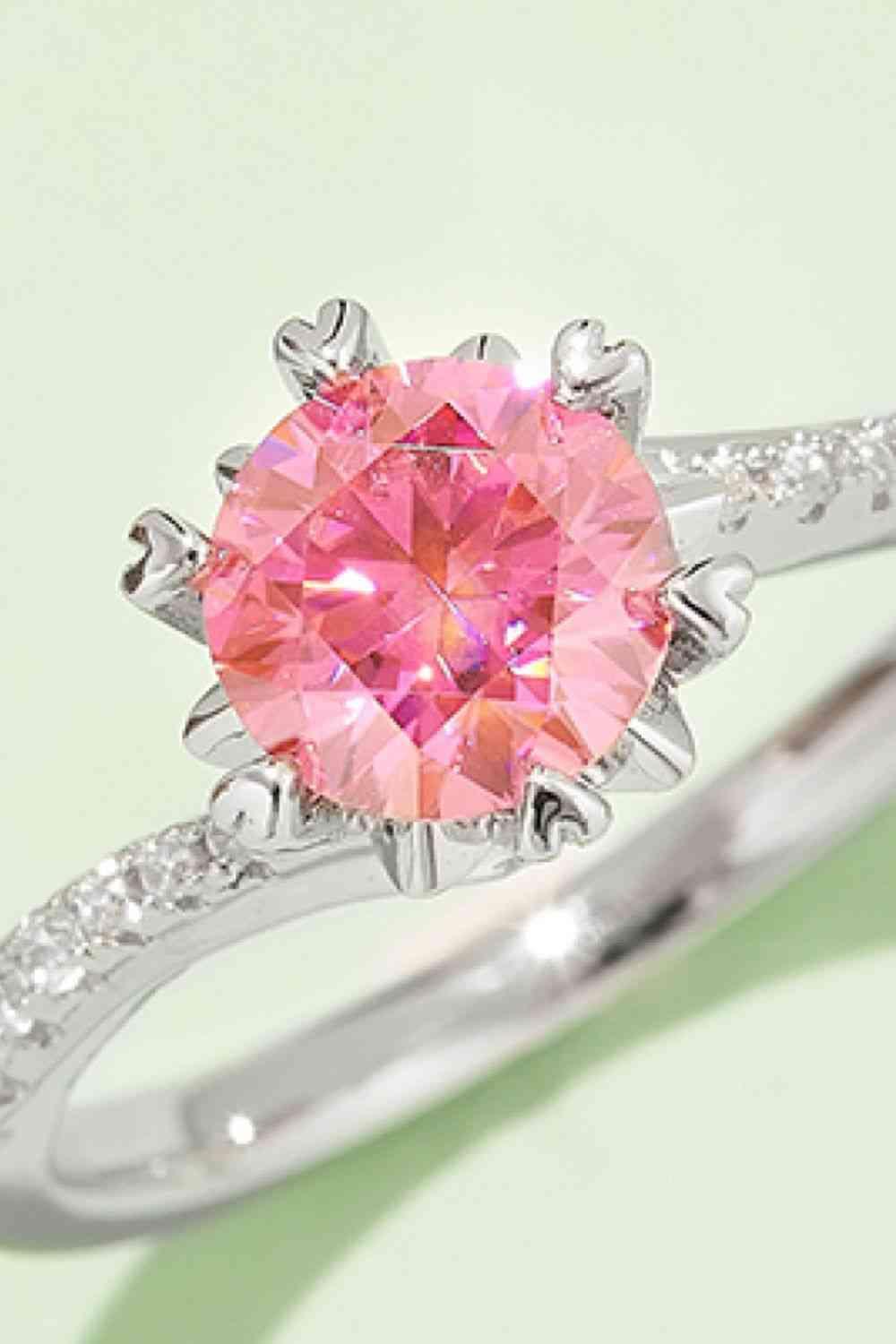 a ring with a pink diamond in the center