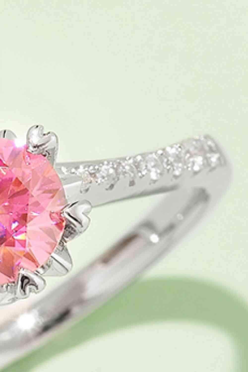 a pink diamond ring with a diamond band