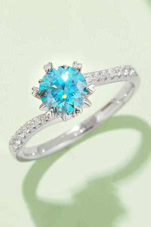 a white gold ring with a blue topaz