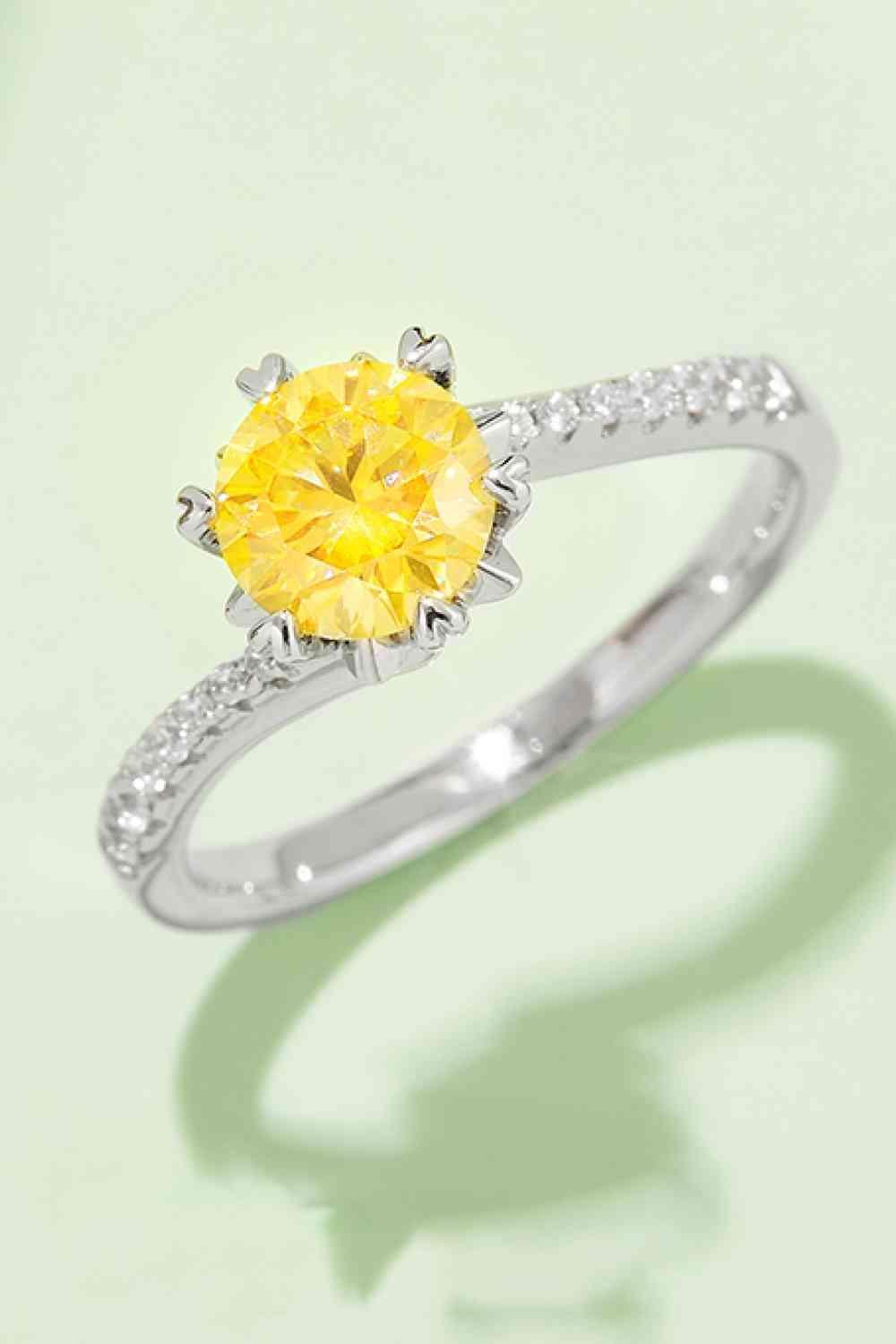 a yellow diamond ring with a diamond band