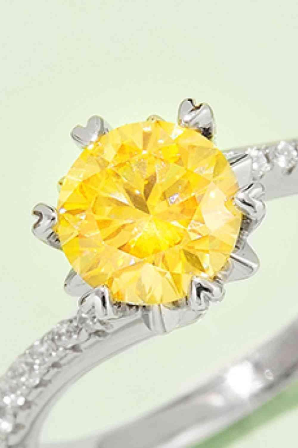 a yellow diamond ring with a diamond band