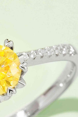 a yellow diamond ring with white diamonds around it