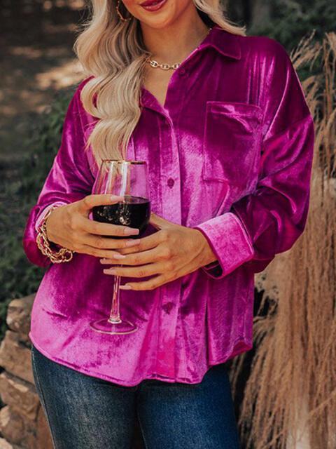 a woman in a pink shirt holding a glass of wine