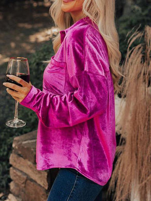 a woman in a pink top holding a wine glass